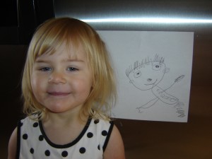My proud, happy daughter showing off a recent drawing!